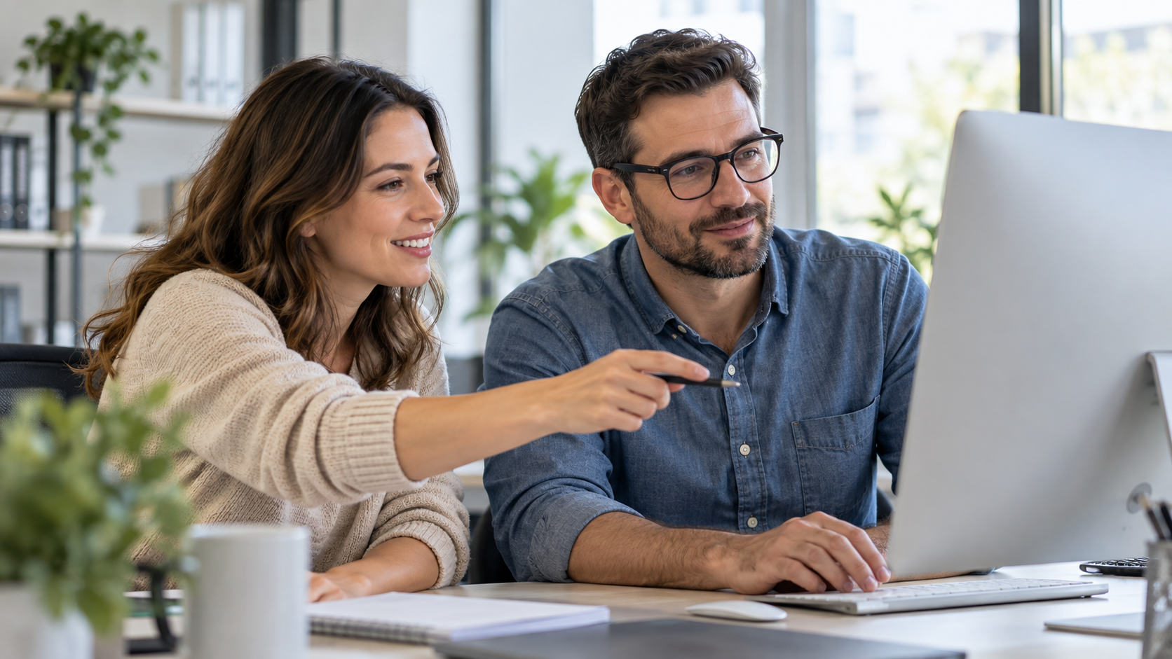 Two business colleagues reviewing a computer together